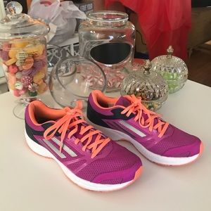 Women’s purple, grey and blue Adidas shoes.